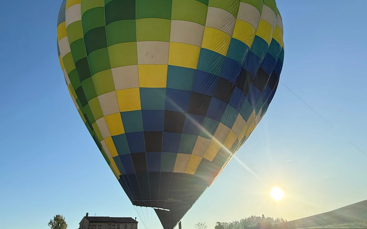 A balloon over the southern Tuscan ridges shortly after sunrise